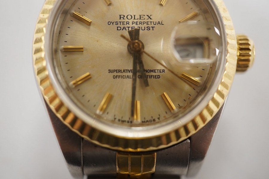 A lady's late 1980's steel and gold Rolex Oyster Perpetual Datejust wrist watch, with baton numerals, serial no. 9773085, on a steel and gold Rolex bracelet, no box or papers. Condition - poor to fair